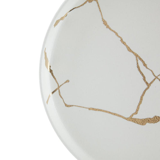 White plate with golden Kintsugi-style cracks.