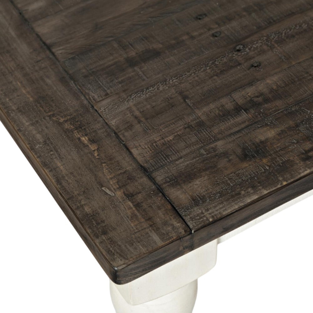 Dark wood table corner with white leg.