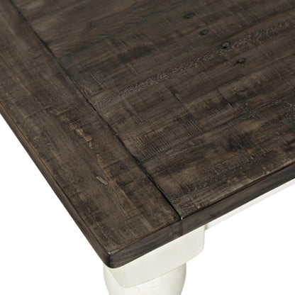 Dark wood table corner with white leg.