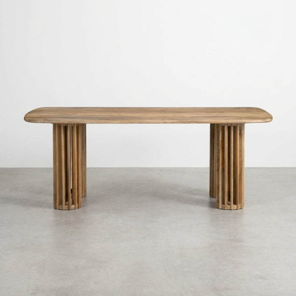 Wooden table with rounded edges and cylindrical legs.