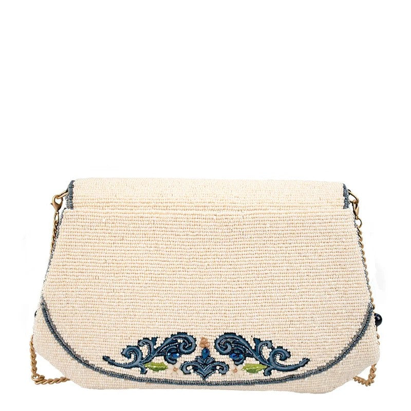 Elegant cream handbag with blue embroidery and a gold chain strap.