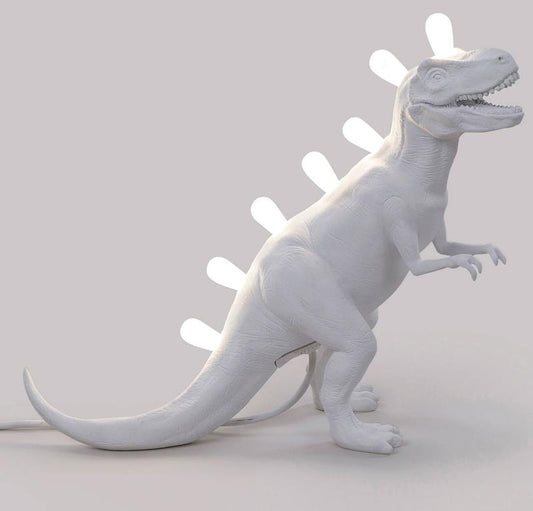 White dinosaur lamp with lightbulbs along its back.