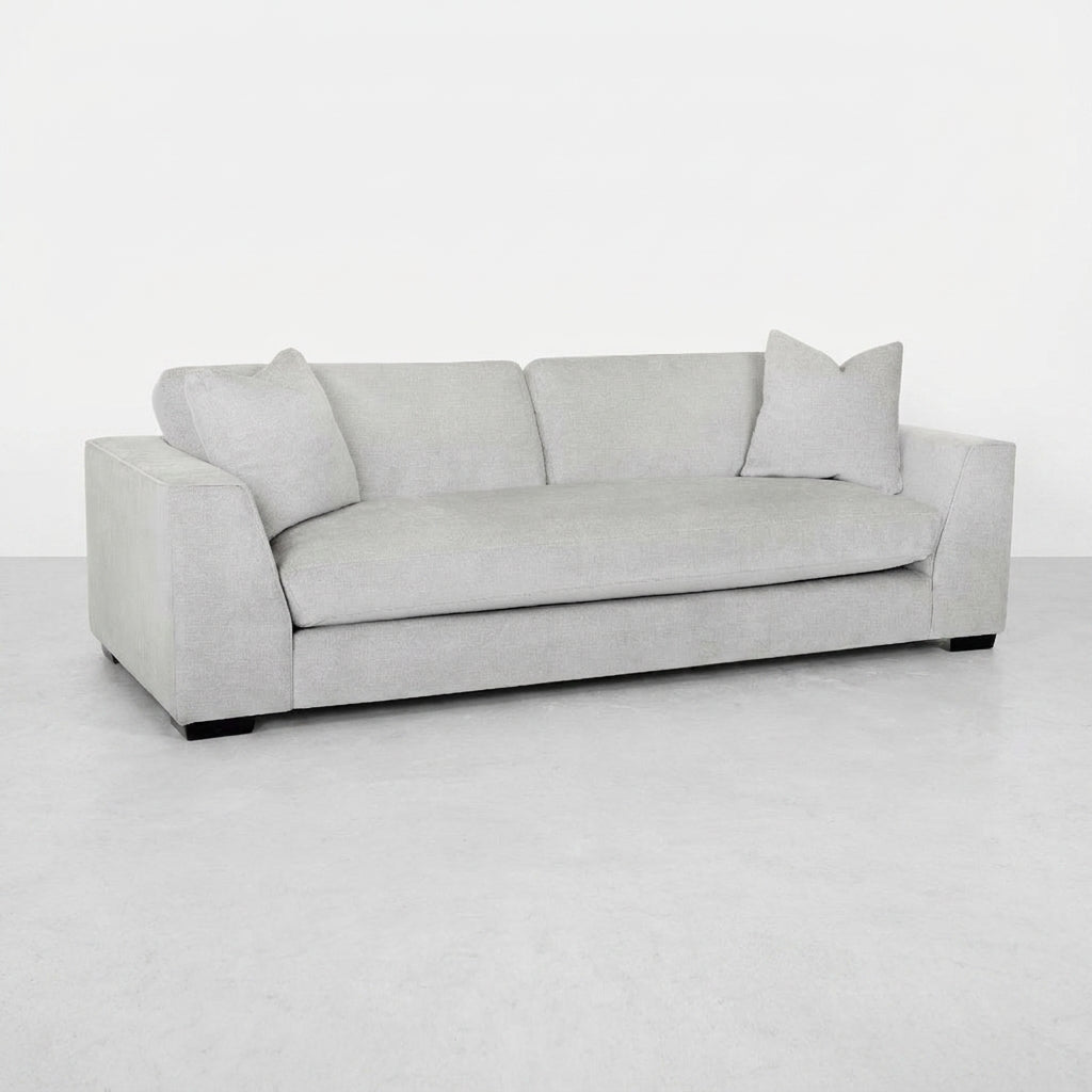 Light gray sofa with two pillows on each end.