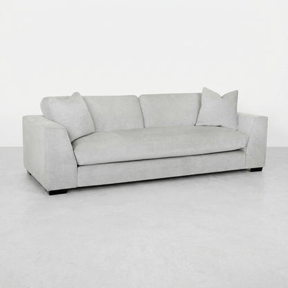 Light gray sofa with two pillows on each end.