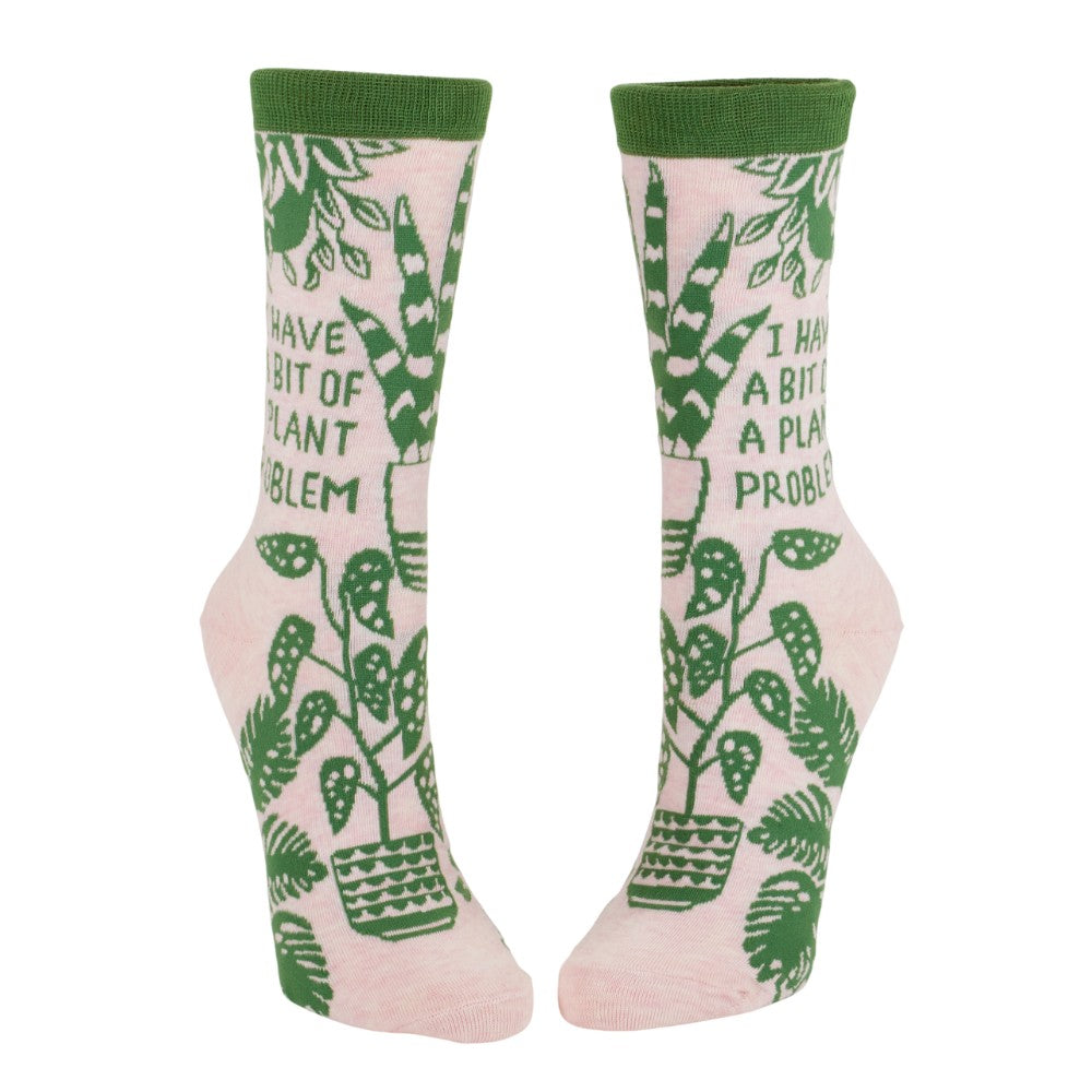 Pink socks with green plant design and humorous text.