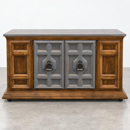 Wooden cabinet with ornate gray doors and metal handles.