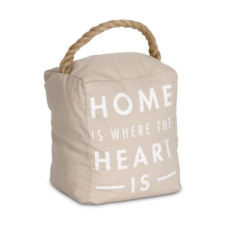 Beige doorstop with rope handle, "Home is where the heart is" text.