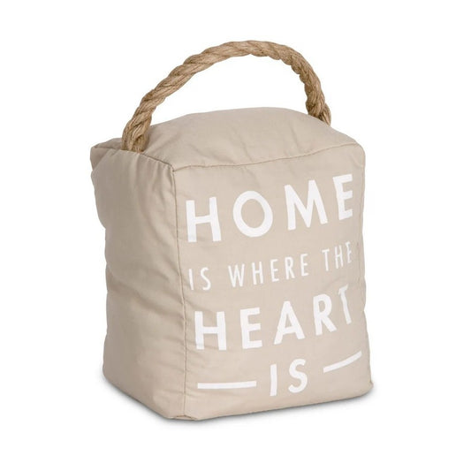 Beige doorstop with rope handle, "Home is where the heart is" text.