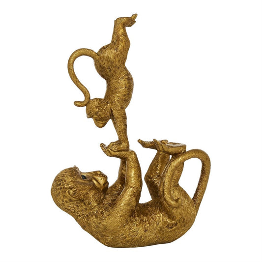 Two gold monkeys playing, balancing in a playful pose.
