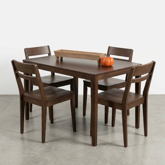 Wooden dining set with a small pumpkin centerpiece.