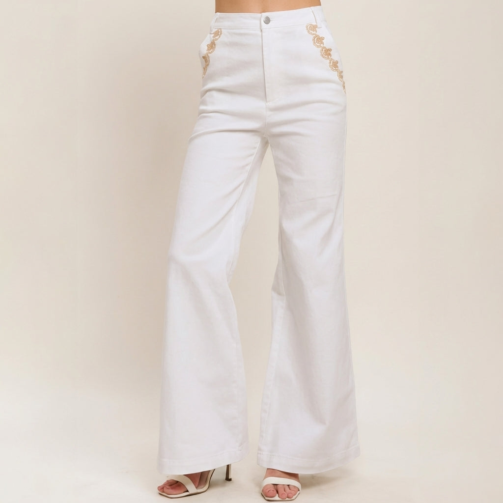 White high-waisted flared jeans with embroidered sides.