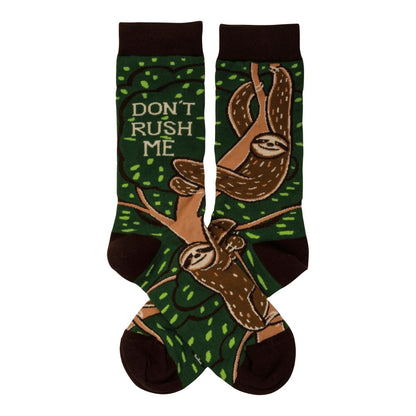 Green socks with sloths and "DON'T RUSH ME" text.