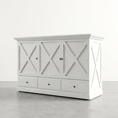 White vintage cabinet with X-panel design and three drawers below.