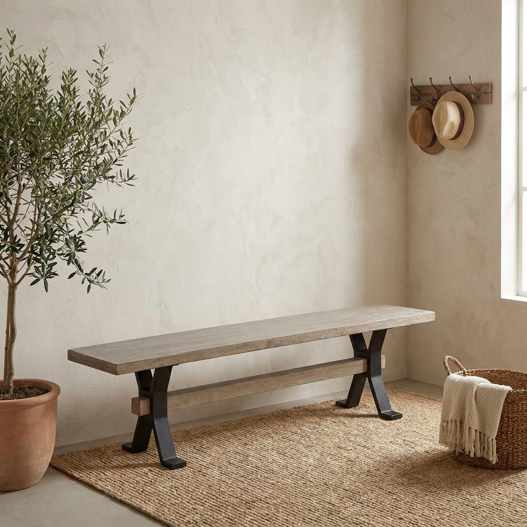 A rustic wooden bench sits in a serene entryway beside a potted tree and woven rug.