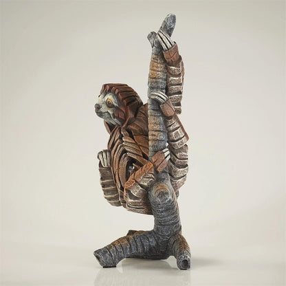 Stone sculpture of a sloth striking a yoga pose.