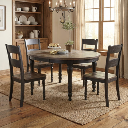 Round table with four chairs, cake, plates, and plant on top.