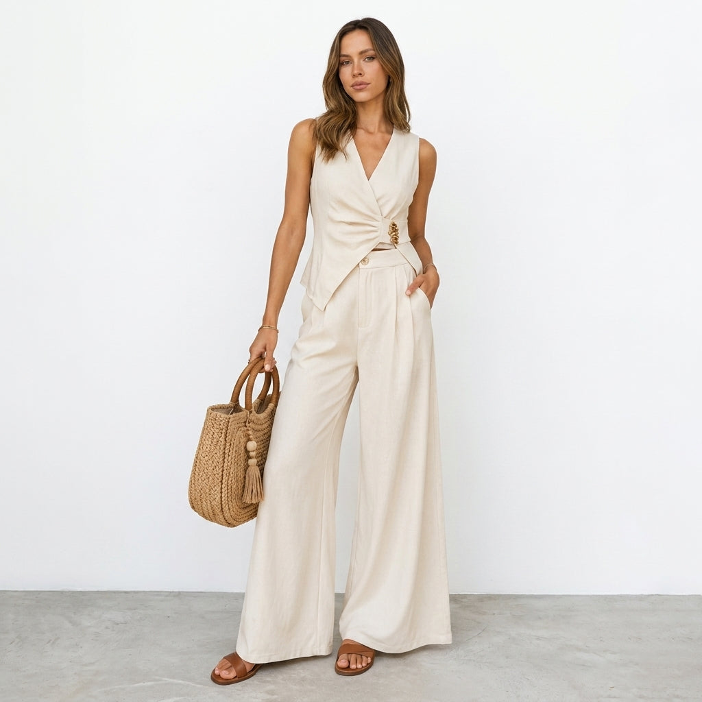 Woman in beige outfit with woven bag, standing against a white background.