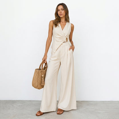 Woman in beige outfit with woven bag, standing against a white background.