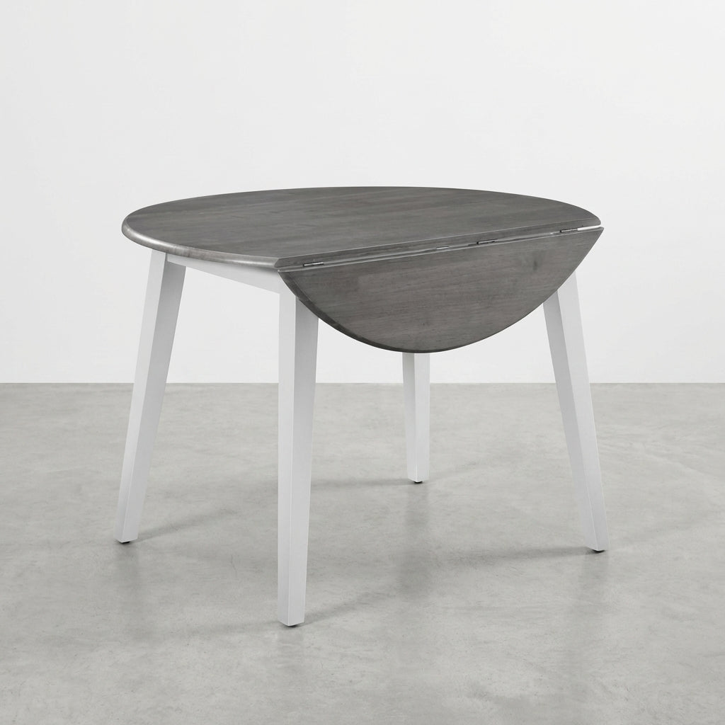 Round drop-leaf table with gray top and white legs.