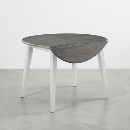 Round drop-leaf table with gray top and white legs.