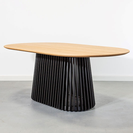 Oval table with wooden top and slatted black base.