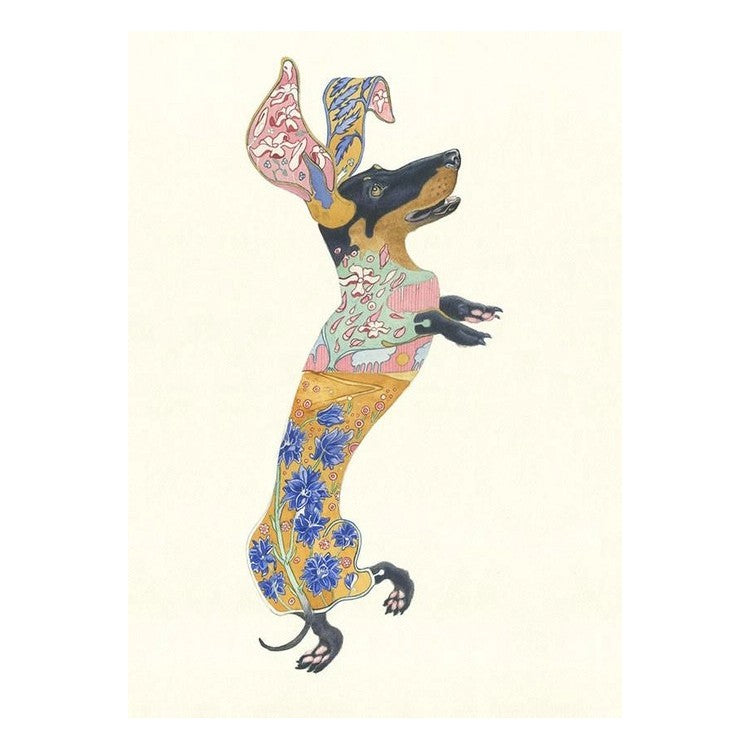 Jumping dog with colorful, floral patterns on the body and ears.