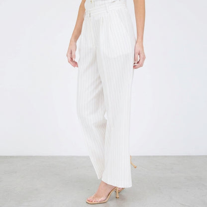 Model wearing white pinstripe pants with heels.