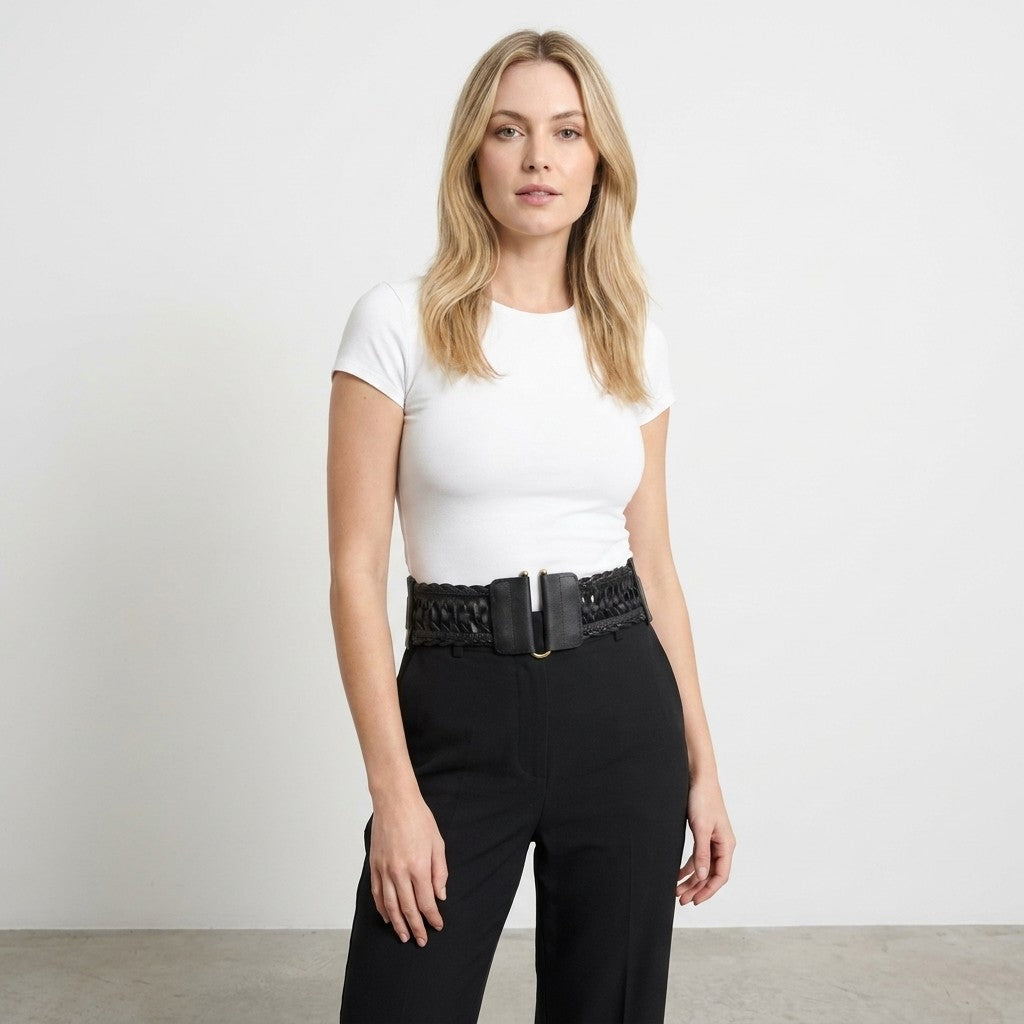 Woman in a white top and black pants.
