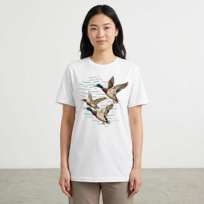 Person wearing a white tee with flying ducks illustration.