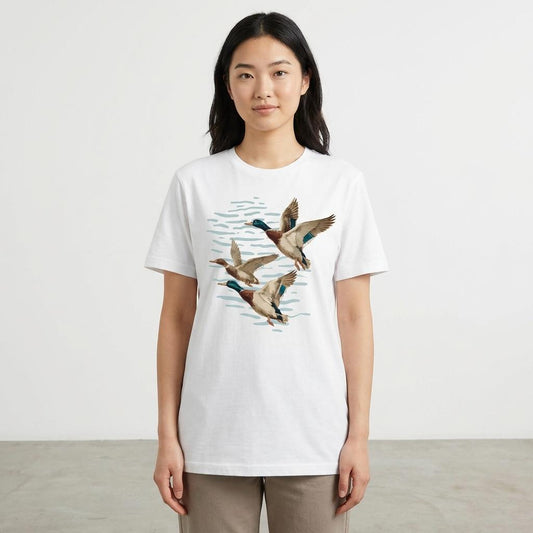 Person wearing a white tee with flying ducks illustration.