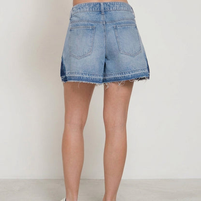 Back view of denim shorts with frayed hem.