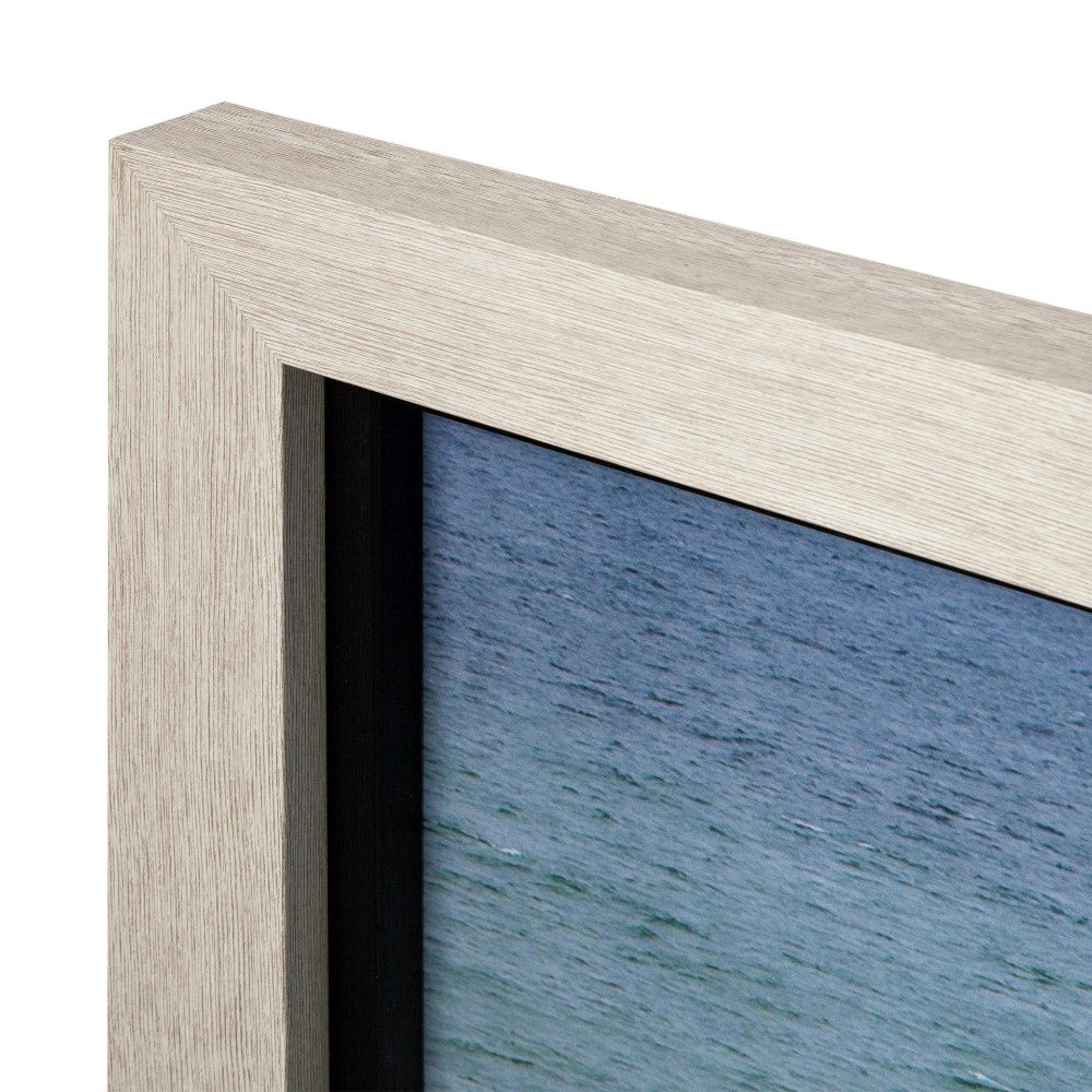 Wooden frame corner with ocean photo detail.
