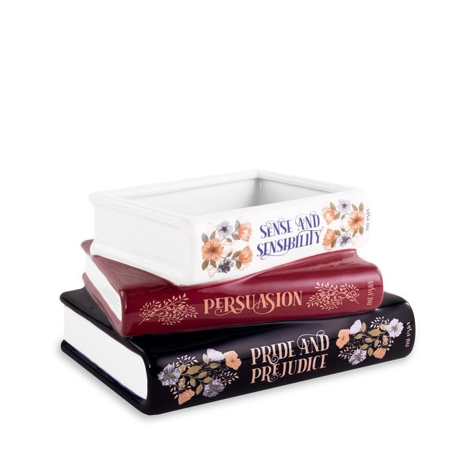 Decorative ceramic books with floral designs stacked together.
