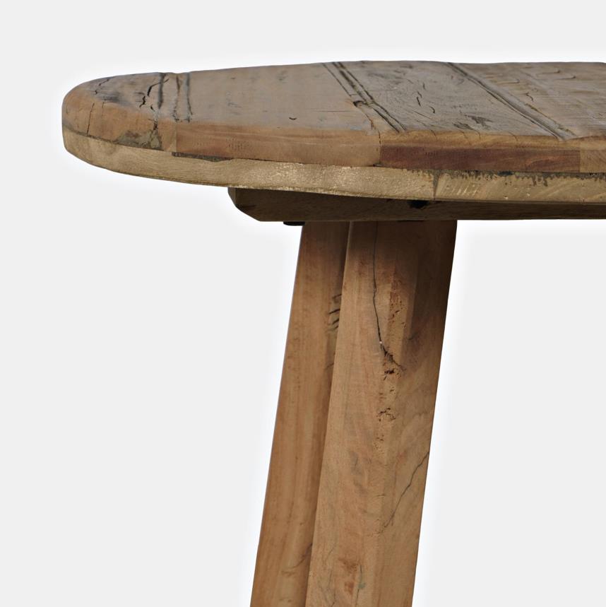 Close-up of a rustic wooden table with a round top and sturdy legs.