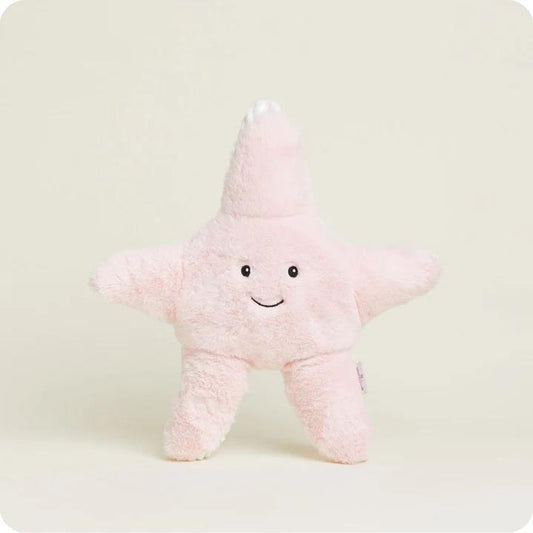 Smiling pink starfish plush on a plain background.