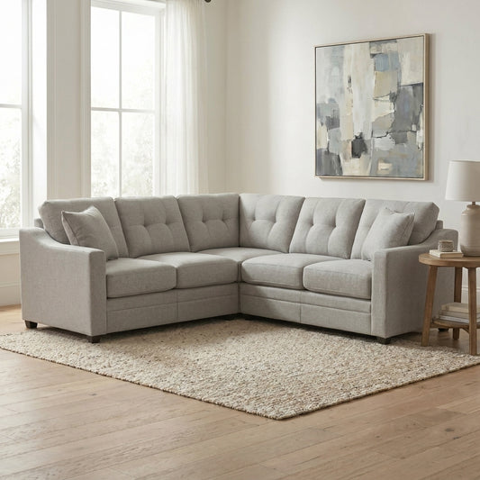Gray sectional sofa in a bright living room with abstract art and wooden floor.