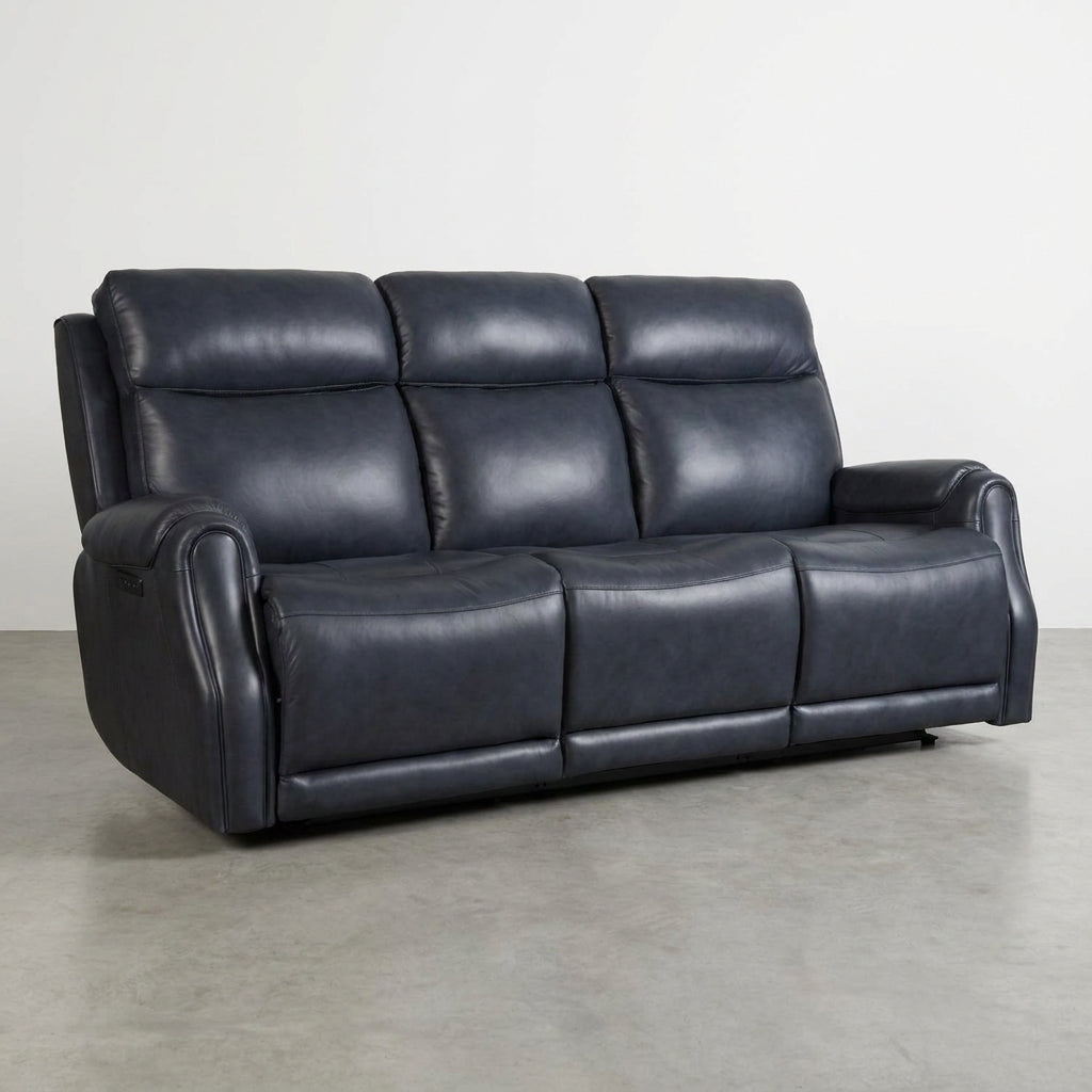 Dark leather reclining sofa on a gray floor.
