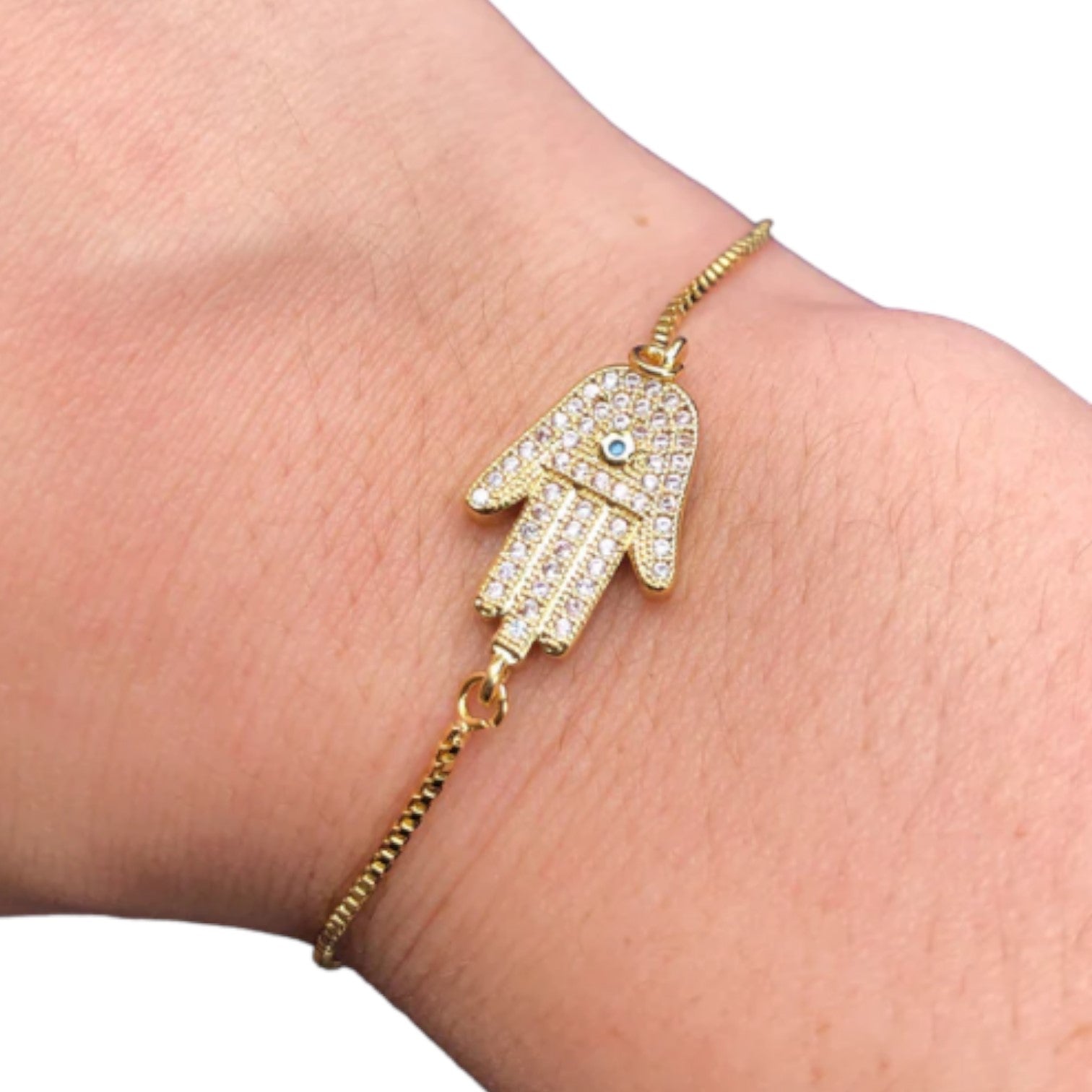 Gold bracelet with a diamond-studded Hamsa hand charm.