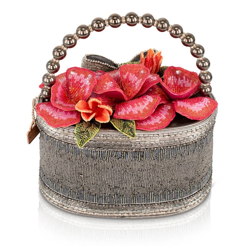 Beaded handbag with floral design and pearl handle.