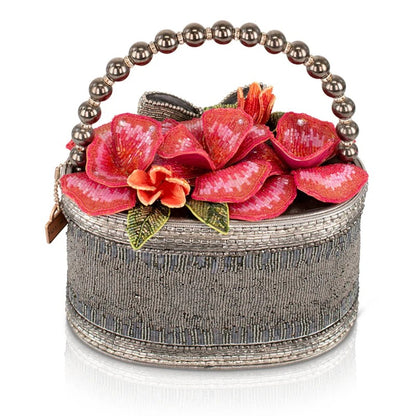 Beaded handbag with floral design and pearl handle.