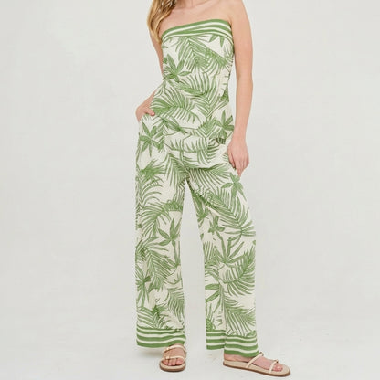 Model in a tropical strapless jumpsuit and sandals.