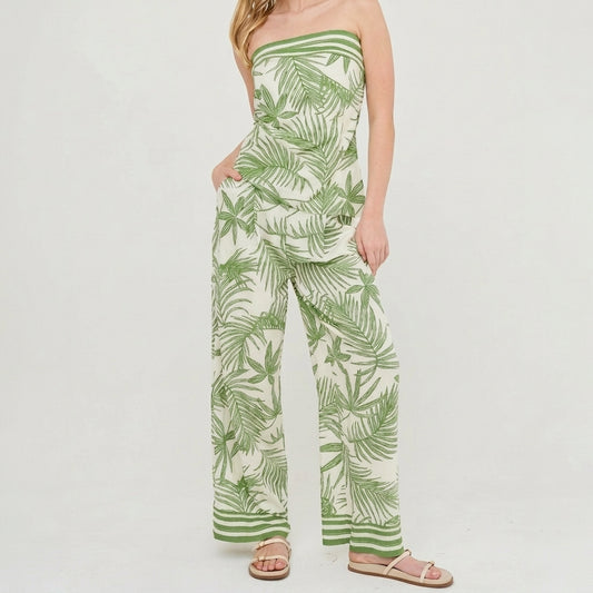Model in a tropical strapless jumpsuit and sandals.