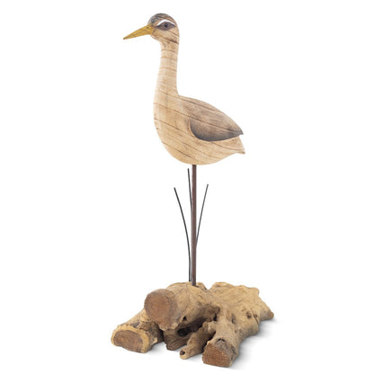 Wooden bird sculpture on a driftwood base.