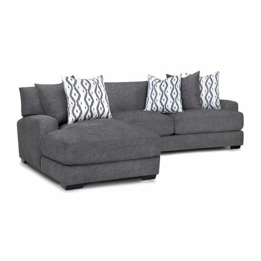 Gray sectional sofa with patterned pillows on a white background.