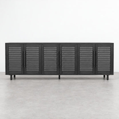 A long dark wood sideboard with six louvered doors stands against a plain white wall.