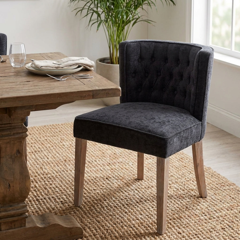 Black tufted chair with wooden legs.