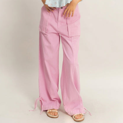 Model in pink wide-leg pants and sandals.
