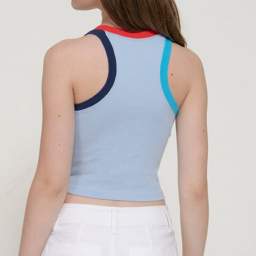 Person in a colorful tank top and white pants, viewed from the back.