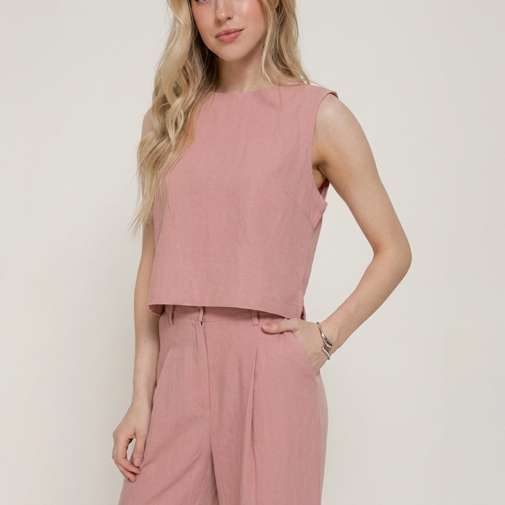 Woman in a pink sleeveless top with matching pants.