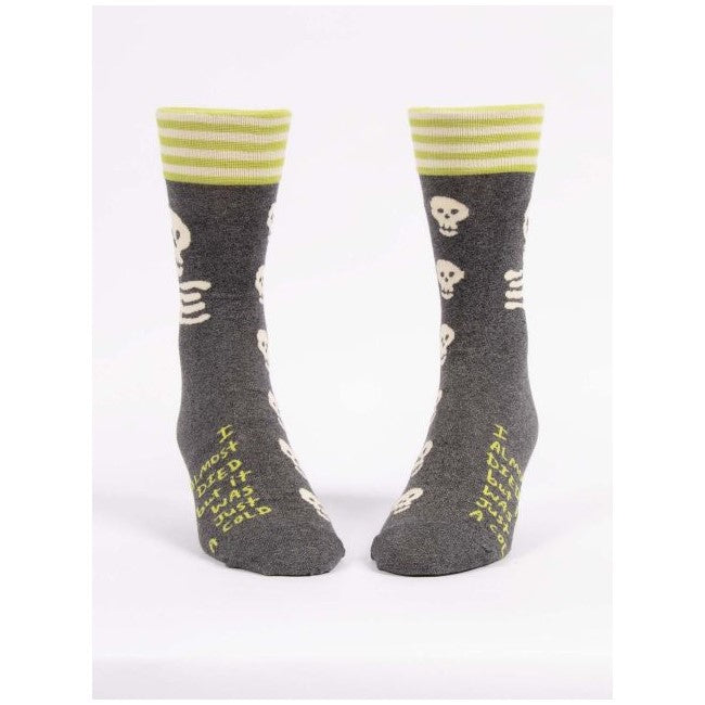 Gray socks with skulls, yellow stripes, and funny text on front.
